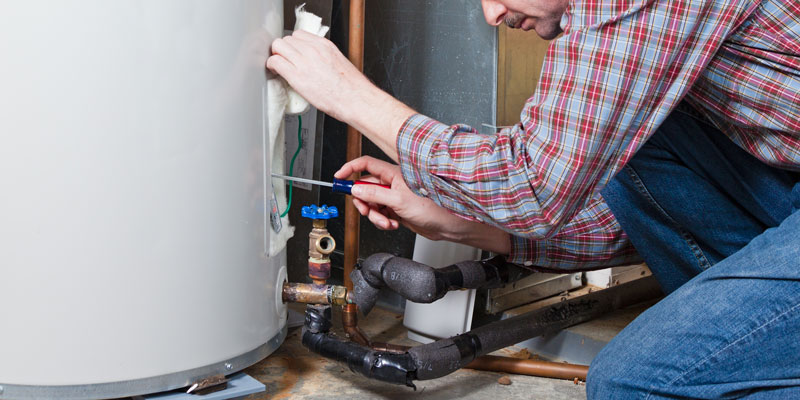 Plumber fixing water heater